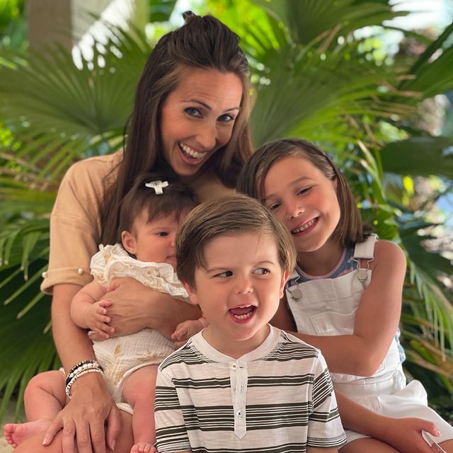 Lauren Simonetti posing with her son and daughters